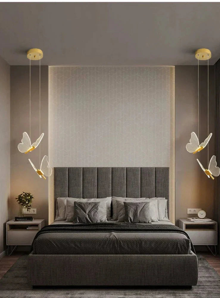 Modern Butterfly LED Pendant Light casting a soft, warm glow in a cozy bedroom—minimalist metal design with gentle ambient lighting for relaxation.