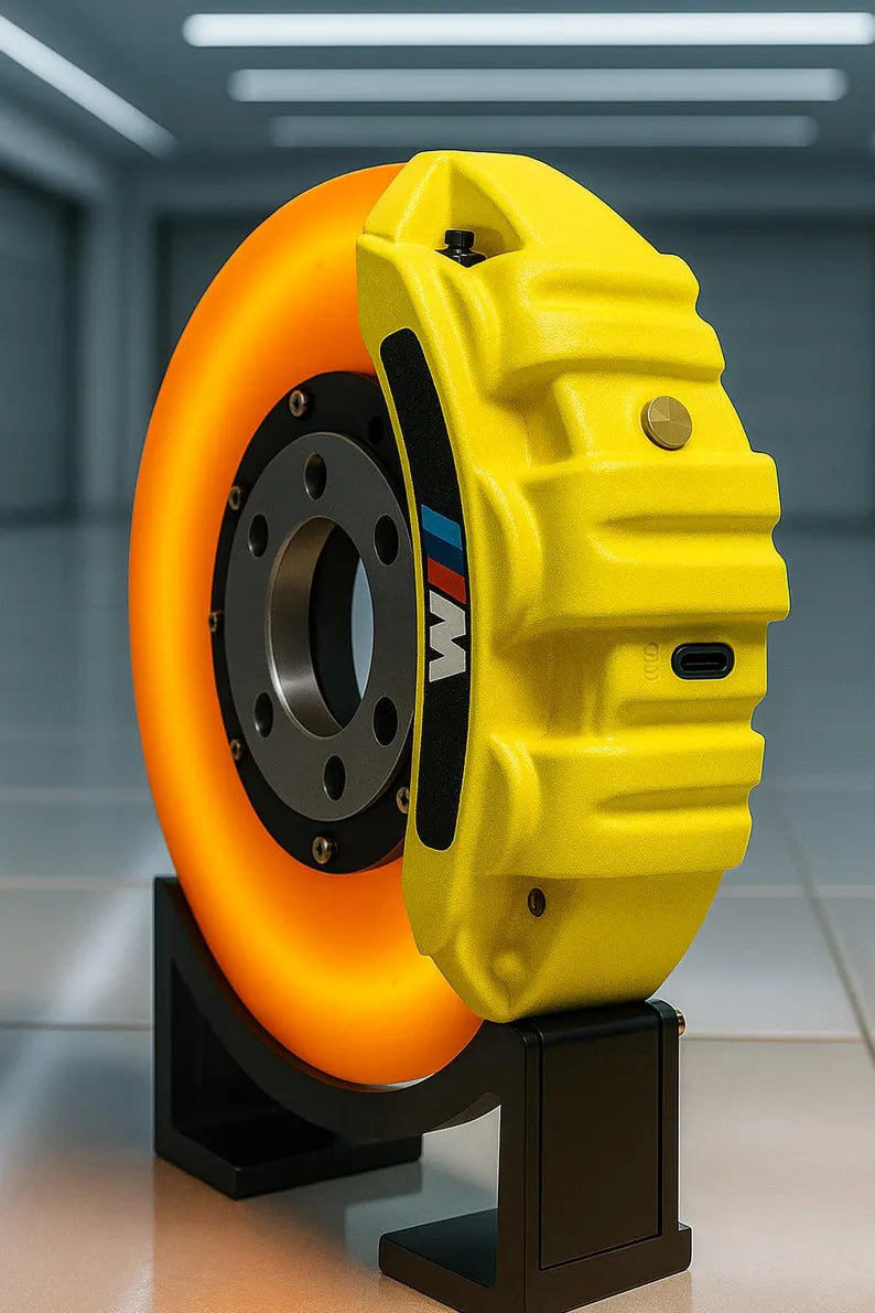Yellow and orange wheel with a black center on a stand against a blurred background