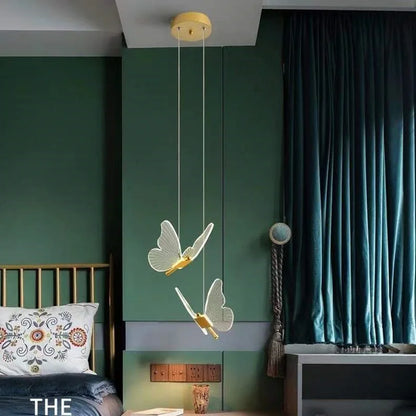Modern bedroom with green walls, a bed, and decorative butterfly pendant light.