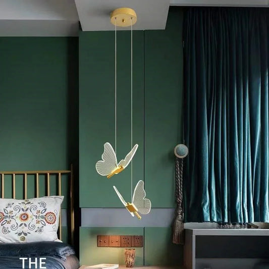 Modern bedroom with green walls, a bed, and decorative butterfly pendant light.
