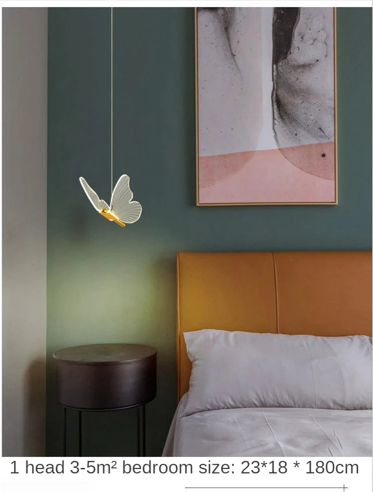 Bedroom interior with a butterfly-shaped light fixture, bed, and wall art.
