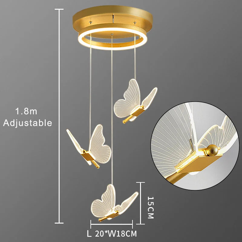 Gold butterfly pendant light with adjustable feature on a gray background